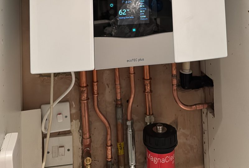 Neat copper pipework and magnetic system filter below a boiler