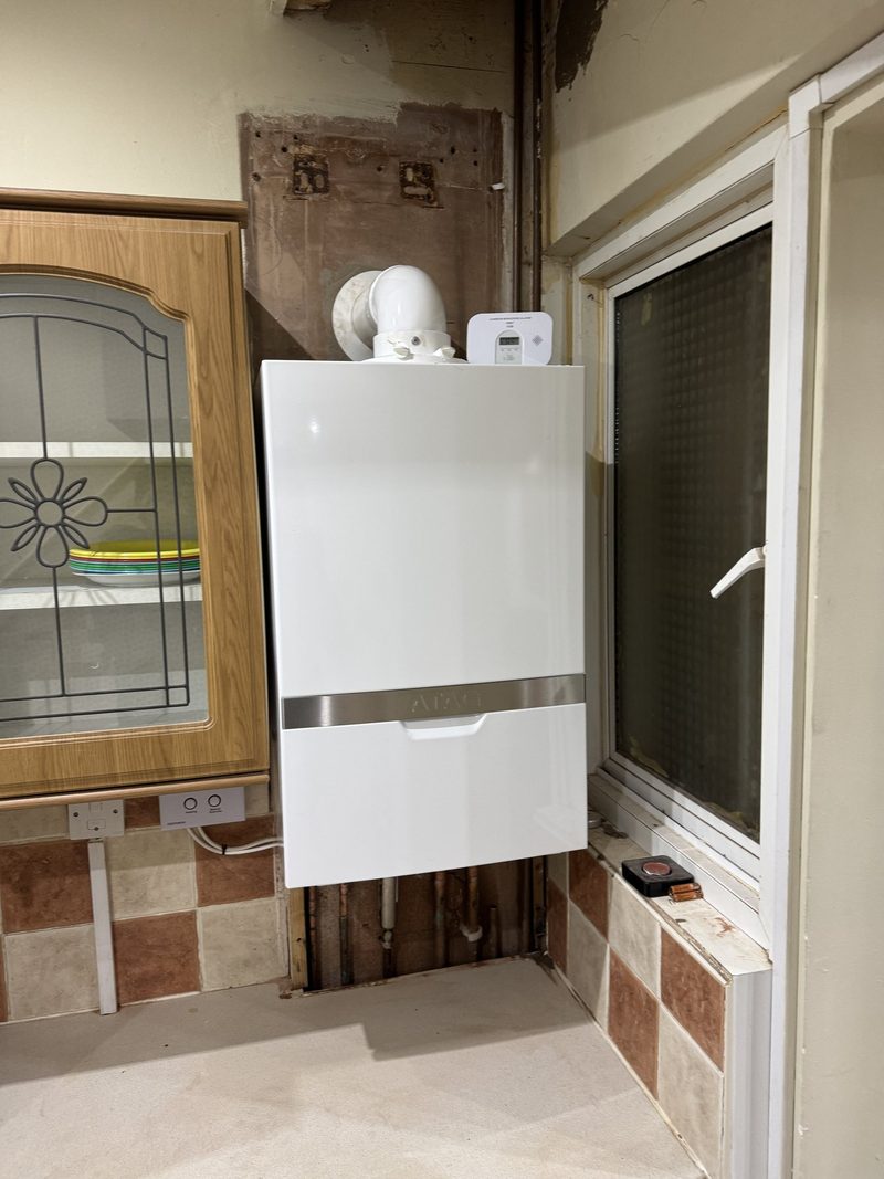 Modern boiler with a neat pipework cover in a kitchen